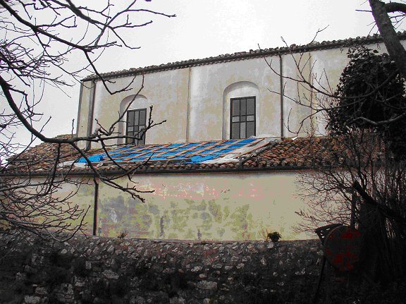 Showing the area of the roof that has collapsed, temporarily covered with a plastic sheet.